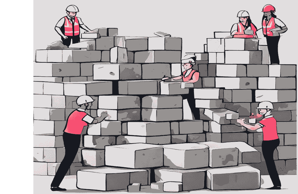 A group of people working on a tetris like set of building blocks, trying to stack the blocks together. 