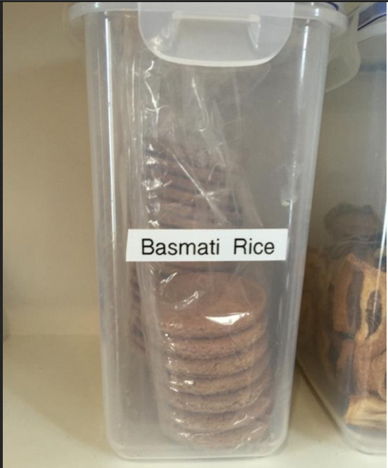 Image showing a large see-through Tupperware container with cookies in it but a label that says Basmati Rice.